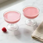 bariatric gelatin recipe served in two clear glass cups on white Carrara marble