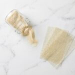 unflavored gelatin powder scattered on white Carrara marble
