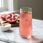 Dr Oz pink gelatin recipe in a clear glass on white marble