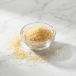 Does gelatin have protein — plain gelatin powder in glass bowl on marble