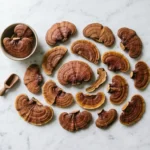 dried reishi mushroom slices on white Carrara marble